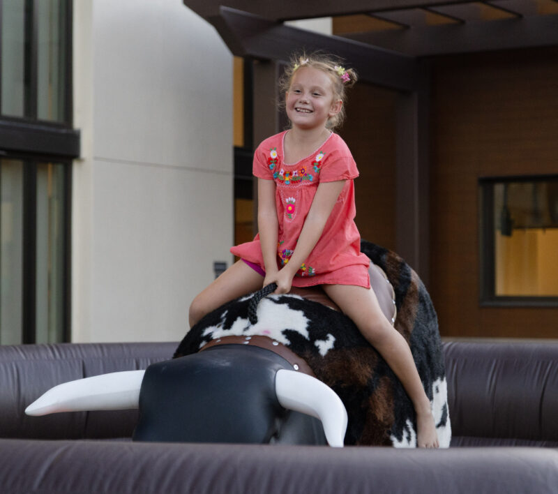 A girl rides a mechanical bull at the final "Celebrate" event highlighting Mexico at Canyon Country Community Center, Thursday, Sept. 10, 2026. Chloe Miller/For The Signal