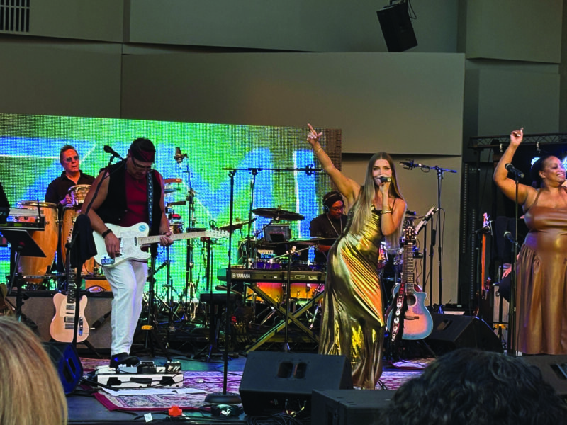 Signer Zimi performs with the ensemble band led by "Nomad and Lala" at the 2026 SCV Music Festival, a fundraiser for the WiSH Education Foundation at California Institute of the Arts. Signal staff photo.