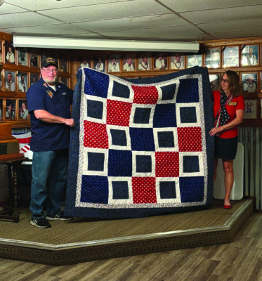Santa Clarita Elks Lodge No. 2379 recently honored Larry Finley (left) with a quilt from the national nonprofit Quilt of Valor Foundation, represented by Donna Kiger (right). Courtesy photo.