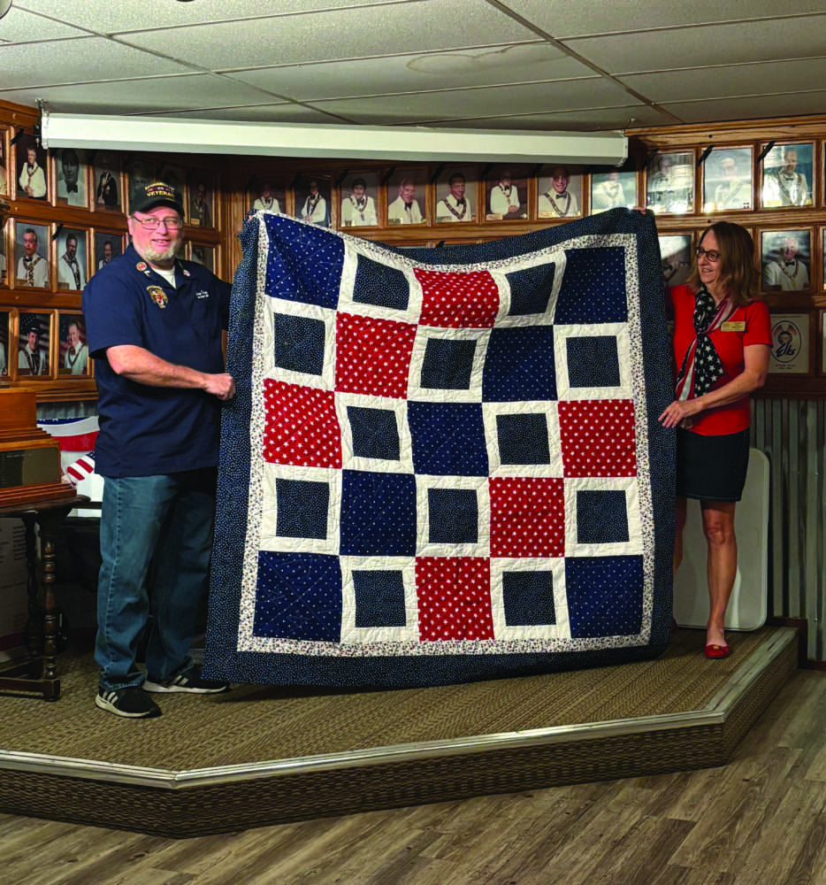 Santa Clarita Elks Lodge No. 2379 recently honored Larry Finley (left) with a quilt from the national nonprofit Quilt of Valor Foundation, represented by Donna Kiger (right). Courtesy photo.