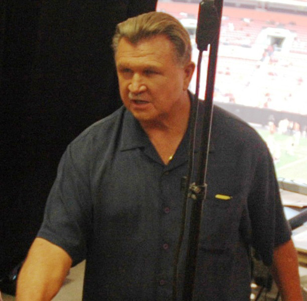Mike Ditka welcomes sailors from amphibious transport dock ship USS Cleveland in the press booth during a National Football League pre-season game between the Cleveland Browns and Chicago Bears at Cleveland Browns Stadium in August 2006. U.S. Navy file photo.
