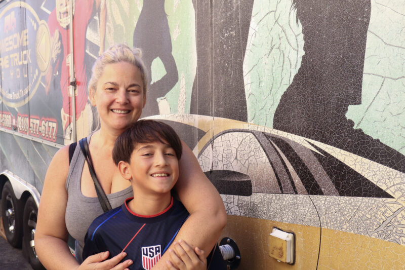Robin Dalton (l) and Thiago Dalton, 9, smile for a photo near the game truck at the Teen FanFest at the Canyon Country Jo Anne Darcy Library in Canyon Country, Calif., Friday, Oct. 9, 2026. Kamryn Martell/The Signal