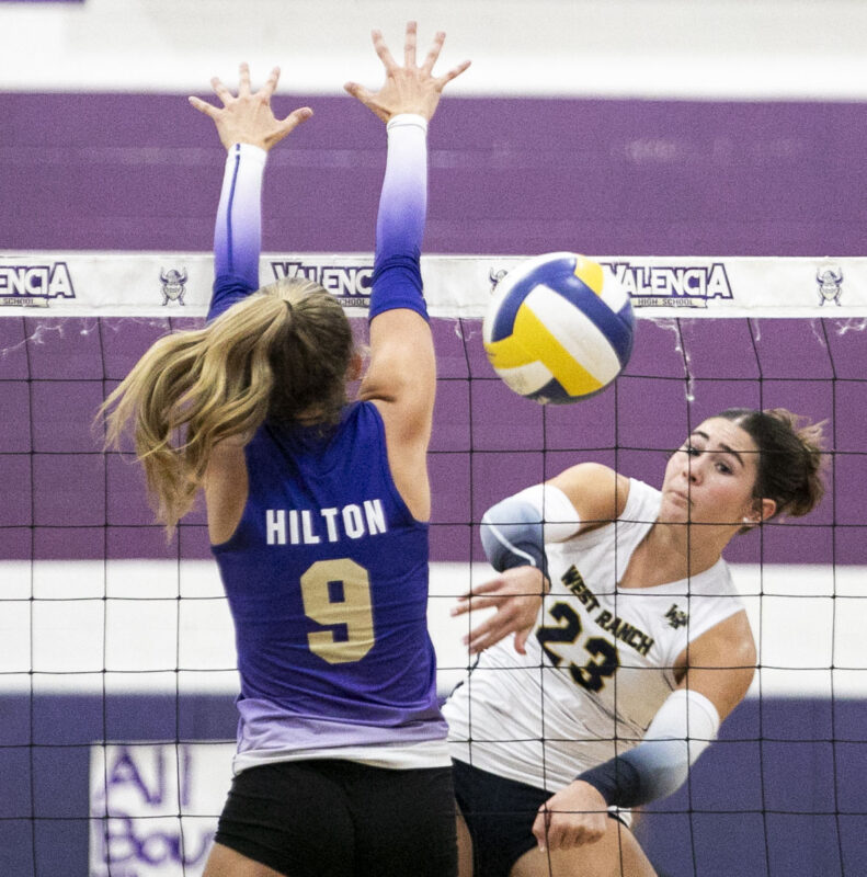 West Ranch outside hitter Lola Van Why (23) hits the ball over the net against Valencia's Faith Hilton (9) during the second set of Tuesday's game at Valencia High School on Sept. 22, 2026. Habeba Mostafa/ The Signal