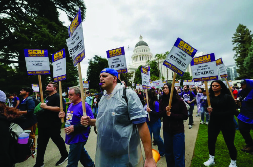 State workers represented by SEIU Local 1000 strike at the state Capitol in Sacramento on Oct. 21, 2026. Photo by Fred Greaves for CalMatters