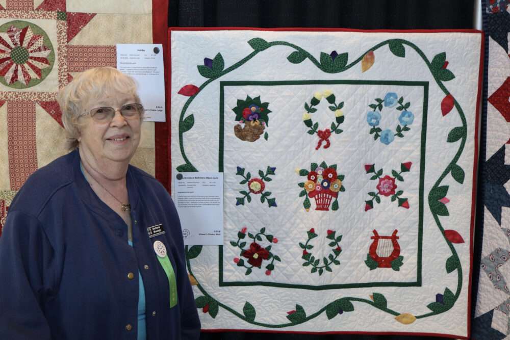 Barbara Montejo smiles next to her decades-long project at the Santa Clarita Valley Quilt Guild's quilt show at the SCV Senior Center at Bella Vida, Sunday, Oct. 25, 2026. Kamryn Martell/The Signal