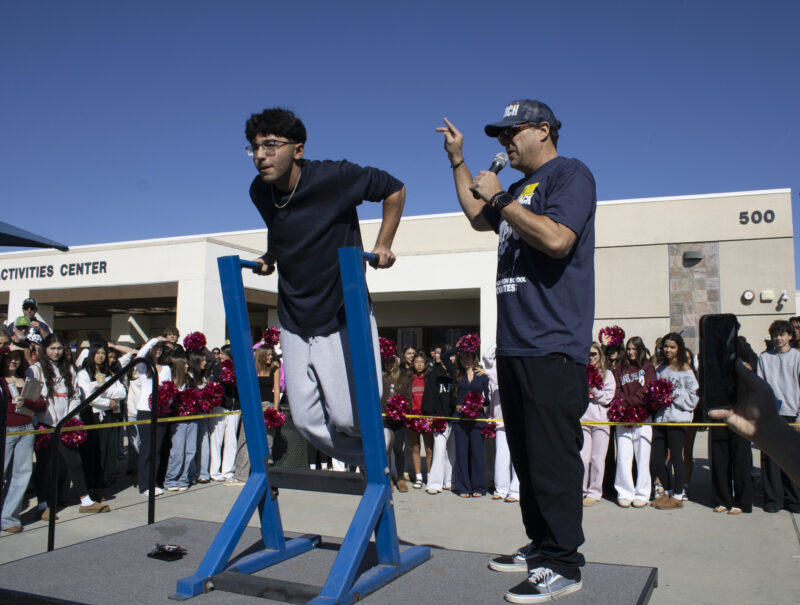 Various students compete in the dipping contest as Petros Papadakis keeps count at West Ranch High School in Valencia, Calif., Wednesday, Oct, 28, 2026. Audrey De Laura/The Signal
