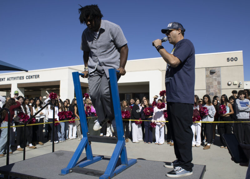 Various students compete in the dipping contest as Petros Papadakis keeps count at West Ranch High School in Valencia, Calif., Wednesday, Oct, 28, 2026. Audrey De Laura/The Signal