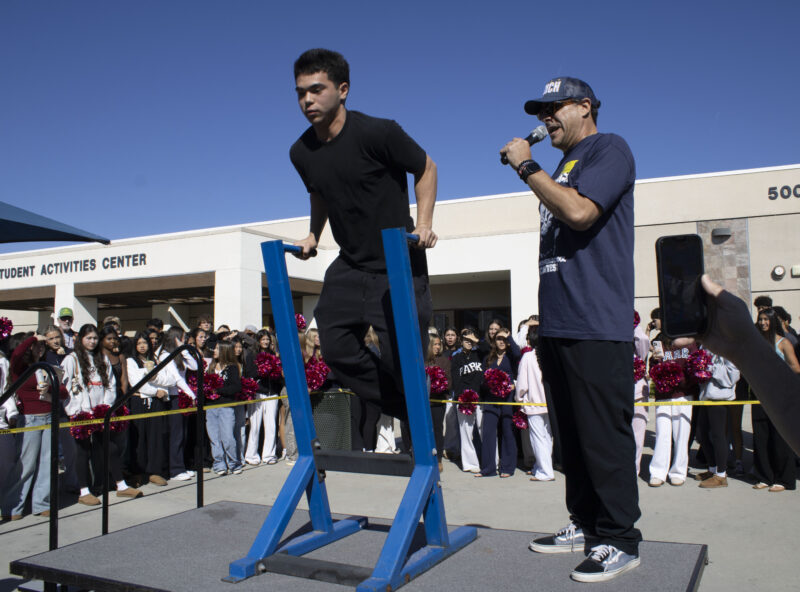 Various students compete in the dipping contest as Petros Papadakis keeps count at West Ranch High School in Valencia, Calif., Wednesday, Oct, 28, 2026. Audrey De Laura/The Signal