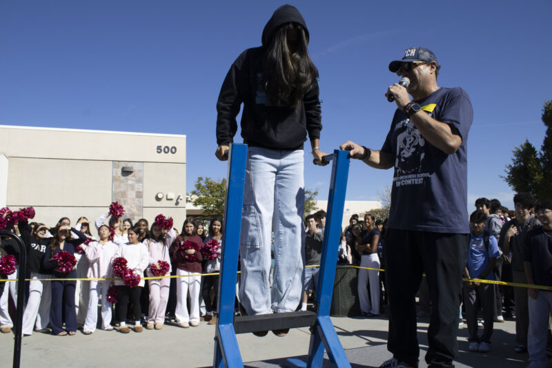 Various students compete in the dipping contest as Petros Papadakis keeps count at West Ranch High School in Valencia, Calif., Wednesday, Oct, 28, 2026. Audrey De Laura/The Signal