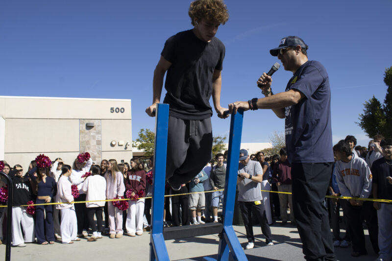 Various students compete in the dipping contest as Petros Papadakis keeps count at West Ranch High School in Valencia, Calif., Wednesday, Oct, 28, 2026. Audrey De Laura/The Signal