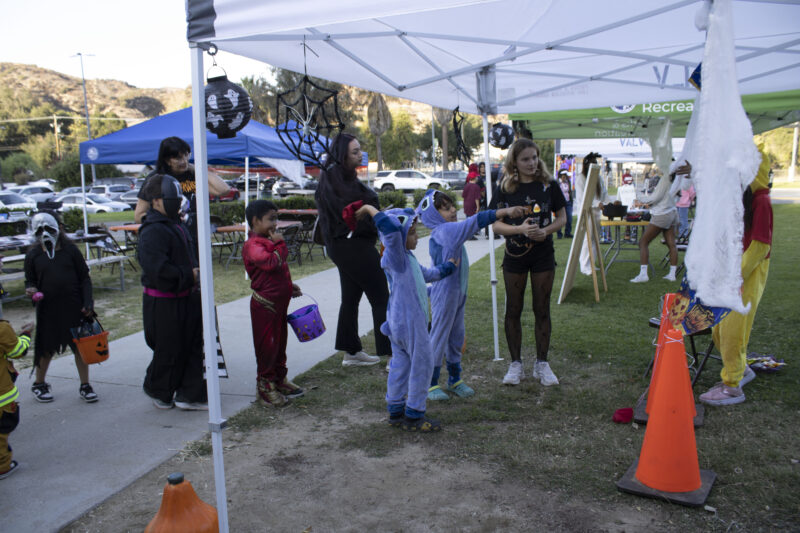 Attendees playing bean bag toss at the Trick or Treat Village at Val Verde Park in Castaic, Calif., Wednesday, Oct, 28, 2026. Audrey De Laura/The Signal